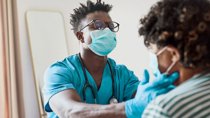 Shot of a young male nurse treating an elderly patient in a nursing home